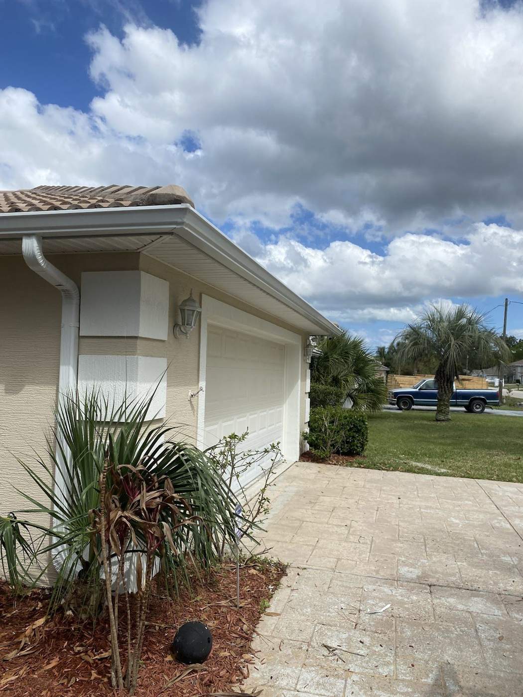 Seamless gutters under tree cover on a Greater Jacksonville home